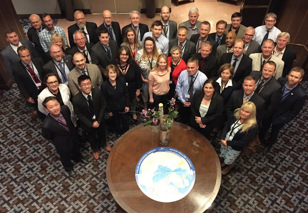 A group of people posing for a picture in a conference room.